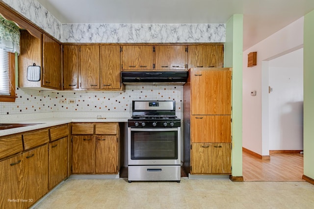 1903 Marshall Pkwy, Waukegan, IL 60085 - kitchen featuring gas stove, under cabinet range hood, decorative backsplash, and brown cabinets