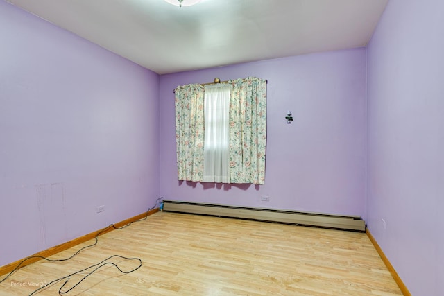 1903 Marshall Pkwy, Waukegan, IL 60085 - unfurnished room with a baseboard radiator, wood finished floors, and baseboards