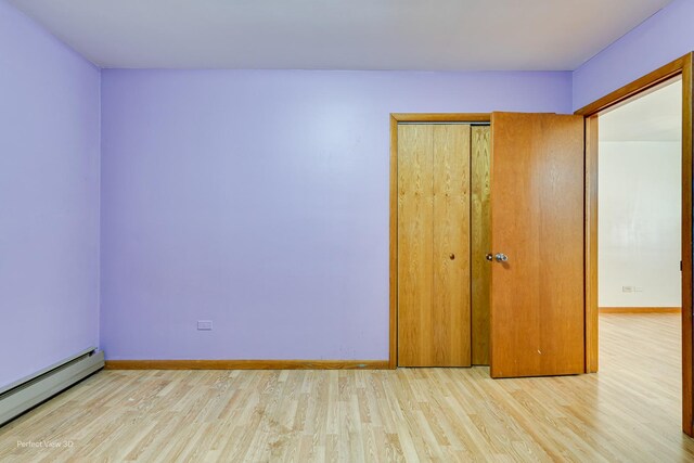 1903 Marshall Pkwy, Waukegan, IL 60085 - empty room with a baseboard radiator, wood finished floors, and baseboards