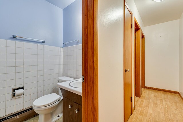 1903 Marshall Pkwy, Waukegan, IL 60085 - bathroom with baseboard heating, toilet, vanity, tile walls, and wood finished floors