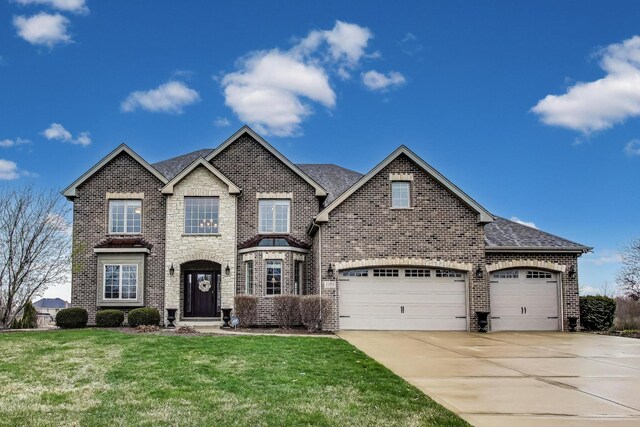 22814 Sara Springs Dr, Frankfort, IL 60423 - view of front of home with brick siding, driveway, a front lawn, a garage, and a shingled roof