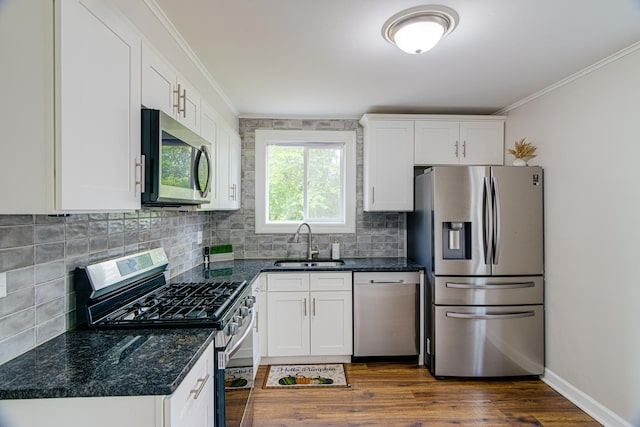 336 Manitowac St, Park Forest, IL 60466 - kitchen featuring appliances with stainless steel finishes, crown molding, decorative backsplash, white cabinetry, and dark wood-style flooring