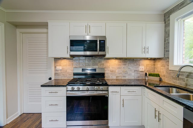 336 Manitowac St, Park Forest, IL 60466 - kitchen featuring stainless steel appliances, dark wood-type flooring, white cabinets, dark stone counters, and ornamental molding