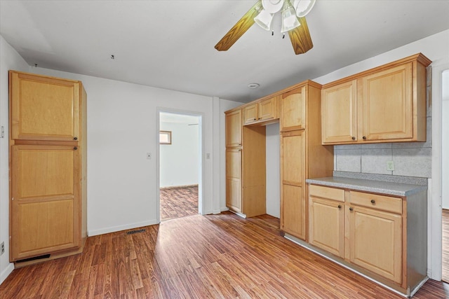 1305 W Beardsley Ave, Urbana, IL 61801 - kitchen with light brown cabinetry, a ceiling fan, light wood-type flooring, light countertops, and tasteful backsplash