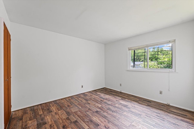 1305 W Beardsley Ave, Urbana, IL 61801 - empty room with dark wood finished floors and baseboards