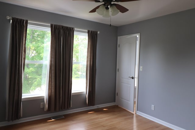 2886 E 6th St, Belvidere, IL 61008 - empty room with a ceiling fan, light wood-type flooring, healthy amount of natural light, and baseboards