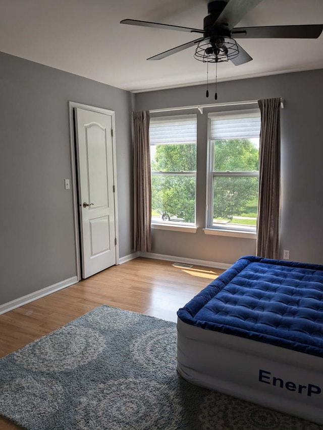2886 E 6th St, Belvidere, IL 61008 - bedroom featuring wood finished floors, baseboards, and a ceiling fan