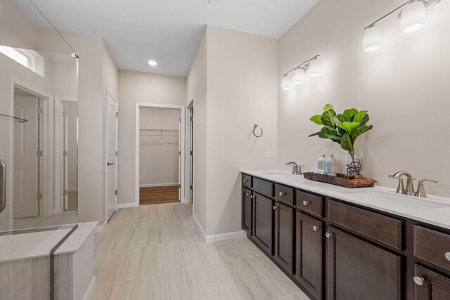 3214 Lincoln Prairie Blvd, Aurora, IL 60503 - bathroom with a shower, double vanity, a spacious closet, baseboards, and tile patterned flooring