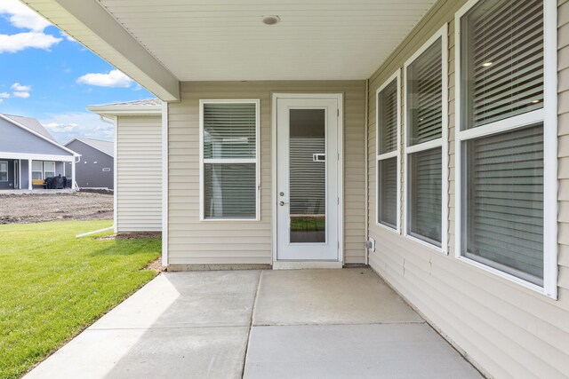 3214 Lincoln Prairie Blvd, Aurora, IL 60503 - view of exterior entry with a patio and a lawn