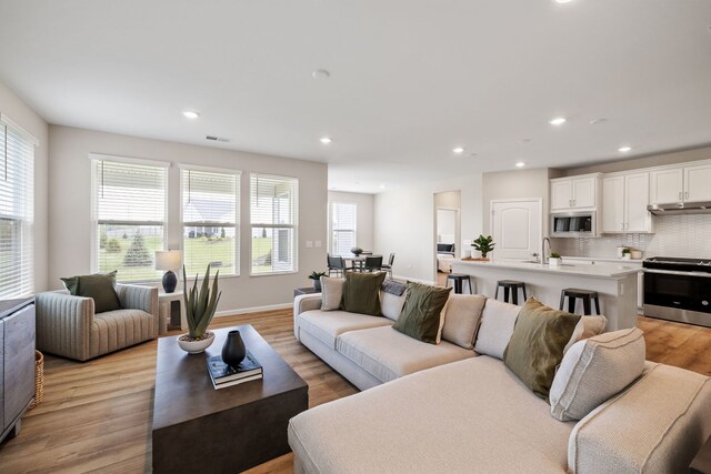 3214 Lincoln Prairie Blvd, Aurora, IL 60503 - living area with healthy amount of natural light, recessed lighting, light wood-style flooring, and baseboards