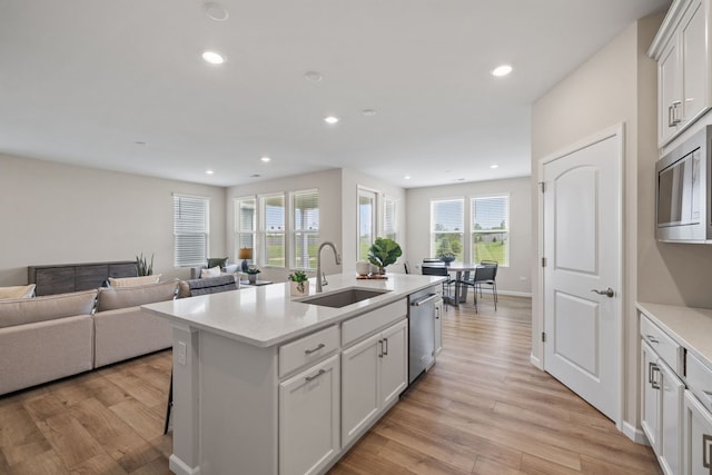 3214 Lincoln Prairie Blvd, Aurora, IL 60503 - kitchen featuring appliances with stainless steel finishes, a sink, light wood finished floors, white cabinets, and recessed lighting
