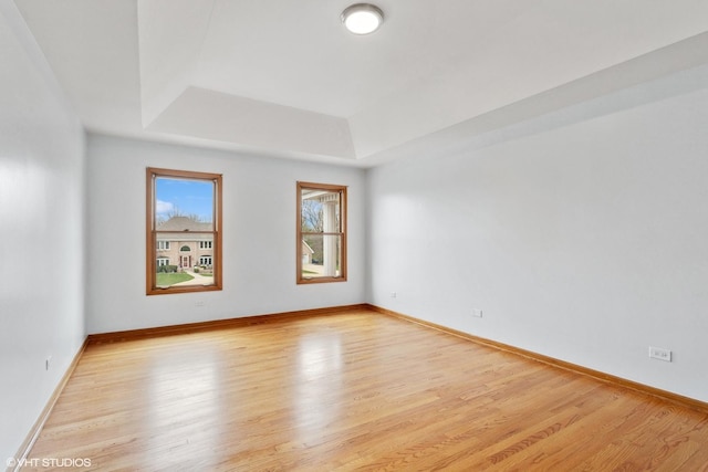 13714 S Janas Pkwy, Homer Glen, IL 60491 - empty room with a tray ceiling, light wood-style floors, and baseboards