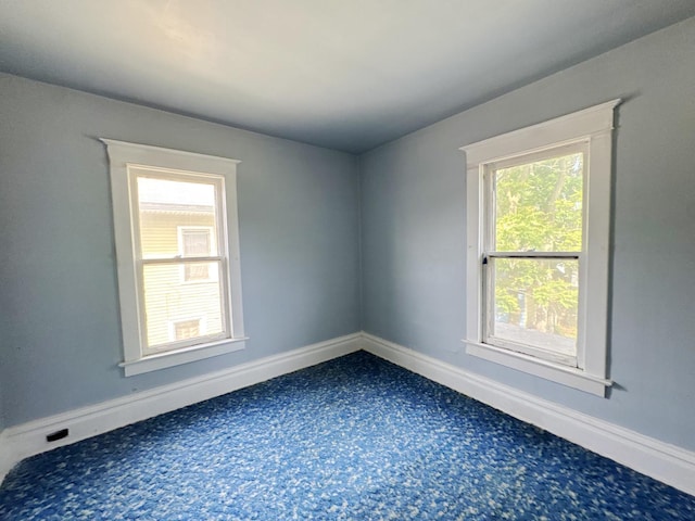 1306 E 4th St, Sterling, IL 61081 - unfurnished room featuring dark carpet and baseboards