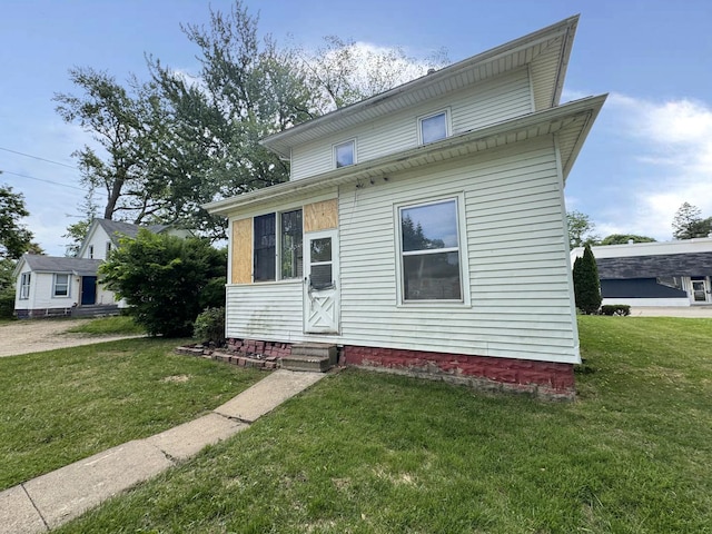 1306 E 4th St, Sterling, IL 61081 - view of front of home with entry steps and a front lawn