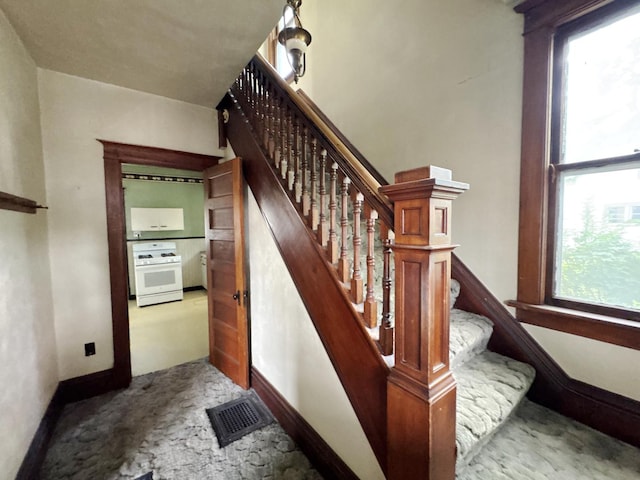 1306 E 4th St, Sterling, IL 61081 - stairs with carpet floors and baseboards