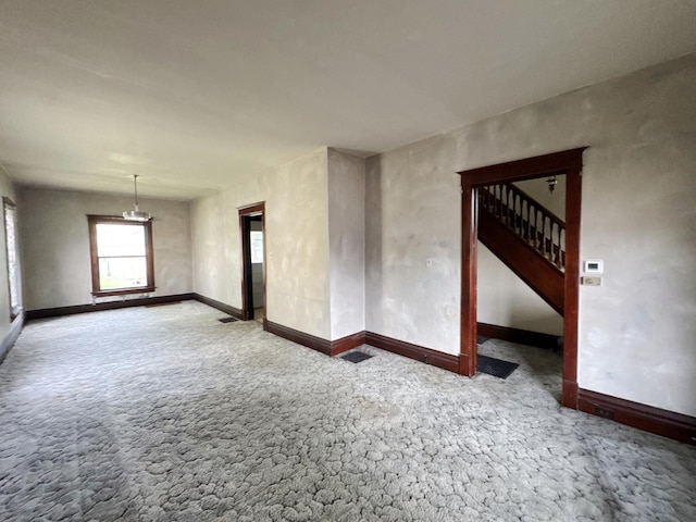 1306 E 4th St, Sterling, IL 61081 - empty room featuring carpet floors, baseboards, and stairs
