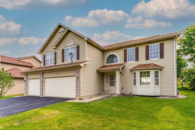 1927 Oaktree Trl, Lake Villa, IL 60046 - view of front of home featuring a garage, asphalt driveway, and a front lawn