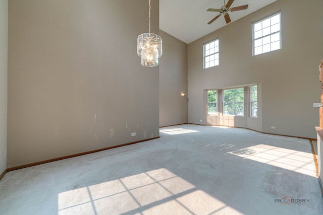 1927 Oaktree Trl, Lake Villa, IL 60046 - unfurnished room with high vaulted ceiling, carpet floors, baseboards, ceiling fan, and a chandelier