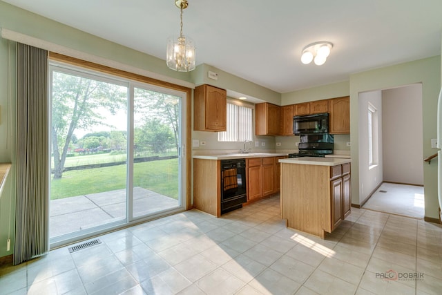 1927 Oaktree Trl, Lake Villa, IL 60046 - kitchen featuring black appliances, light countertops, a kitchen island, a sink, and decorative light fixtures