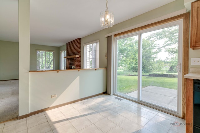 1927 Oaktree Trl, Lake Villa, IL 60046 - unfurnished dining area featuring a brick fireplace, baseboards, and a chandelier