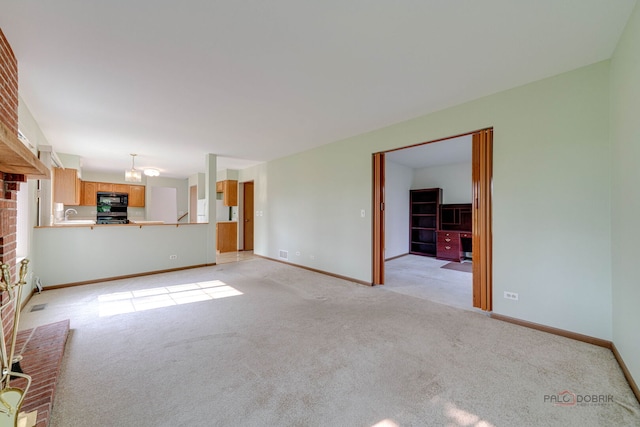 1927 Oaktree Trl, Lake Villa, IL 60046 - unfurnished living room with light colored carpet, baseboards, and a sink