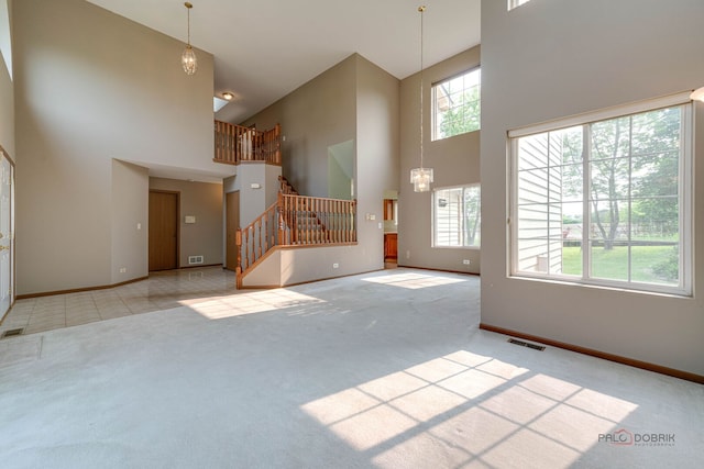 1927 Oaktree Trl, Lake Villa, IL 60046 - unfurnished living room featuring a high ceiling, carpet flooring, stairway, and baseboards
