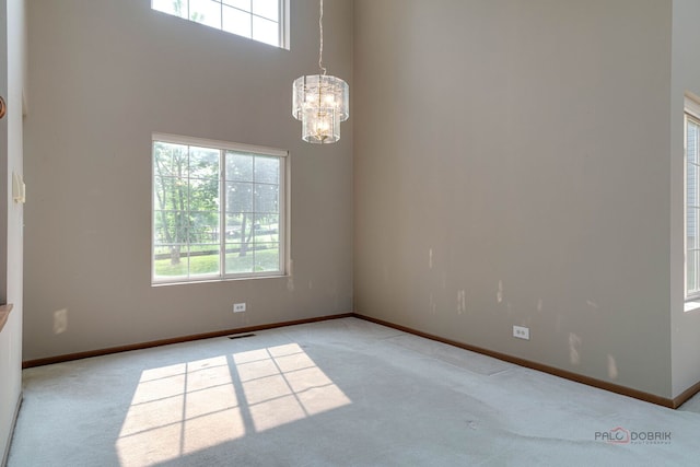 1927 Oaktree Trl, Lake Villa, IL 60046 - unfurnished room with light carpet, a chandelier, baseboards, and a high ceiling