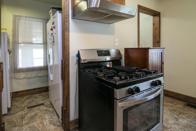 4391 N State Route 1-17, Momence, IL 60954 - kitchen with stainless steel range with gas cooktop, exhaust hood, and freestanding refrigerator