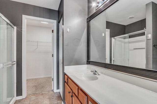 743 Sycamore Ct, Lindenhurst, IL 60046 - bathroom with a shower stall, a spacious closet, vanity, and tile patterned floors