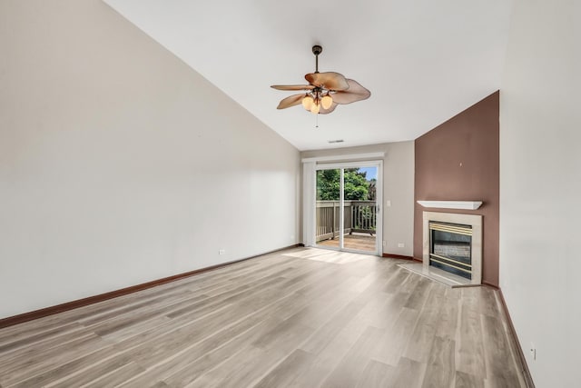 743 Sycamore Ct, Lindenhurst, IL 60046 - unfurnished living room featuring ceiling fan, a glass covered fireplace, light wood-style flooring, and vaulted ceiling