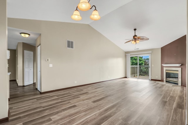 743 Sycamore Ct, Lindenhurst, IL 60046 - unfurnished living room featuring lofted ceiling, ceiling fan, wood finished floors, and a premium fireplace