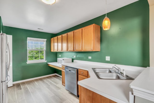 743 Sycamore Ct, Lindenhurst, IL 60046 - kitchen with appliances with stainless steel finishes, light wood-style floors, hanging light fixtures, and light countertops