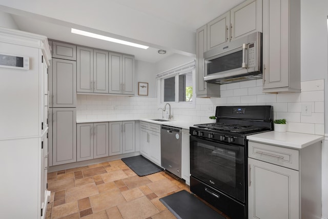 1850 Pierce Rd, Hoffman Estates, IL 60169 - kitchen featuring black range with gas stovetop, white microwave, stainless steel dishwasher, and gray cabinets