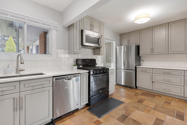 1850 Pierce Rd, Hoffman Estates, IL 60169 - kitchen with stainless steel appliances, a sink, gray cabinets, light countertops, and backsplash
