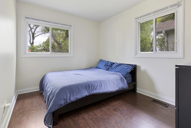 1850 Pierce Rd, Hoffman Estates, IL 60169 - bedroom with multiple windows, wood finished floors, and baseboards
