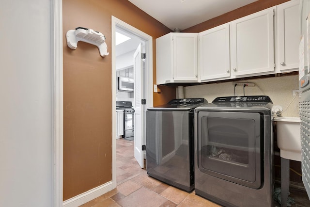 1850 Pierce Rd, Hoffman Estates, IL 60169 - laundry area featuring cabinet space, separate washer and dryer, baseboards, and light stone finish floors