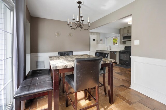 1850 Pierce Rd, Hoffman Estates, IL 60169 - dining area featuring a chandelier and wainscoting