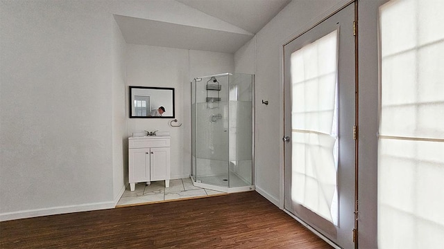 1 S Stanton St, Shannon, IL 61078 - bathroom featuring a stall shower, vaulted ceiling, wood finished floors, vanity, and baseboards