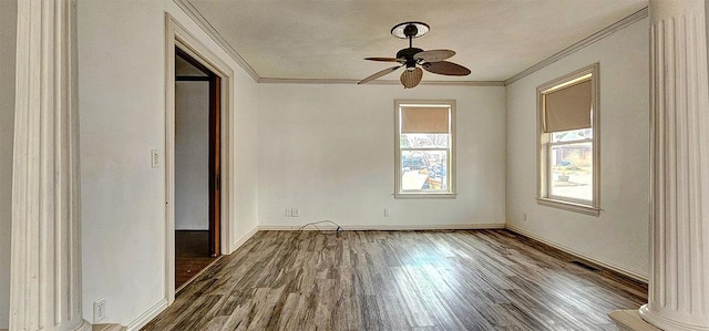 1 S Stanton St, Shannon, IL 61078 - unfurnished room with crown molding, wood finished floors, a ceiling fan, baseboards, and ornate columns