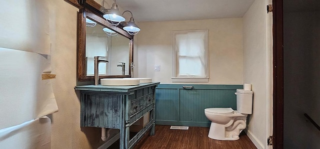 1 S Stanton St, Shannon, IL 61078 - bathroom with toilet, wood finished floors, vanity, and a wainscoted wall
