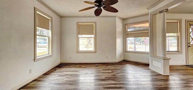 1 S Stanton St, Shannon, IL 61078 - unfurnished room with crown molding, wood finished floors, ceiling fan, baseboards, and ornate columns