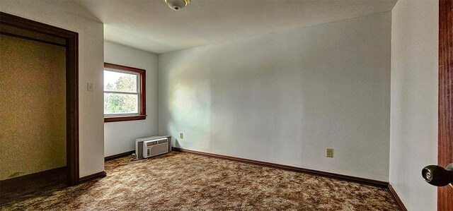 1 S Stanton St, Shannon, IL 61078 - unfurnished bedroom featuring carpet floors, a wall mounted air conditioner, and baseboards