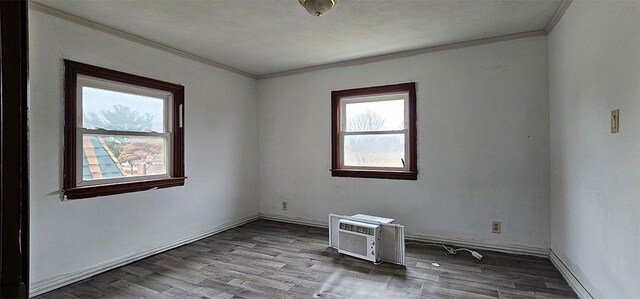 1 S Stanton St, Shannon, IL 61078 - empty room featuring crown molding, wood finished floors, an AC wall unit, and baseboards