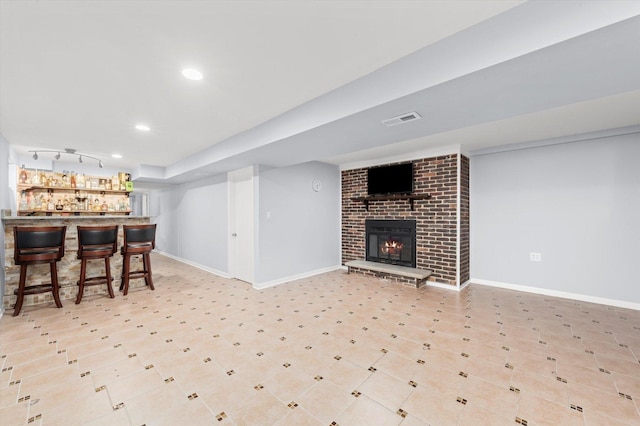 5642 W Dakin St, Chicago, IL 60634 - living area featuring bar area, baseboards, recessed lighting, a brick fireplace, and track lighting