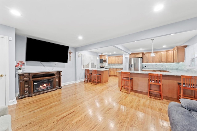 5642 W Dakin St, Chicago, IL 60634 - living area with light wood-style floors, recessed lighting, baseboards, and a glass covered fireplace