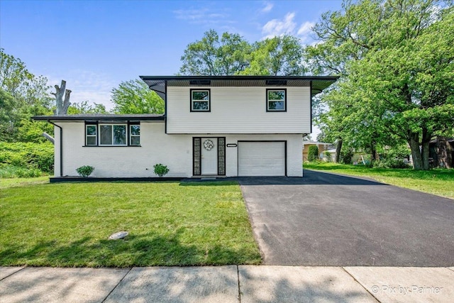 14028 S Wayman Ln, Robbins, IL 60472 - tri-level home featuring a garage, driveway, a front yard, and brick siding