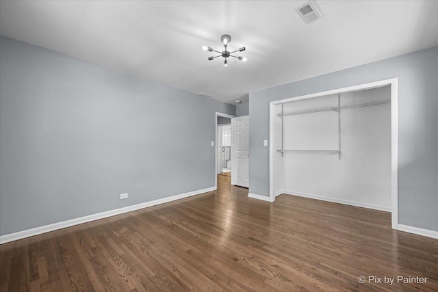 14028 S Wayman Ln, Robbins, IL 60472 - unfurnished bedroom with a chandelier, wood finished floors, and a closet