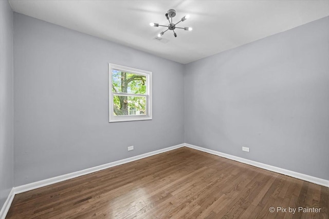 14028 S Wayman Ln, Robbins, IL 60472 - empty room with a chandelier and wood finished floors