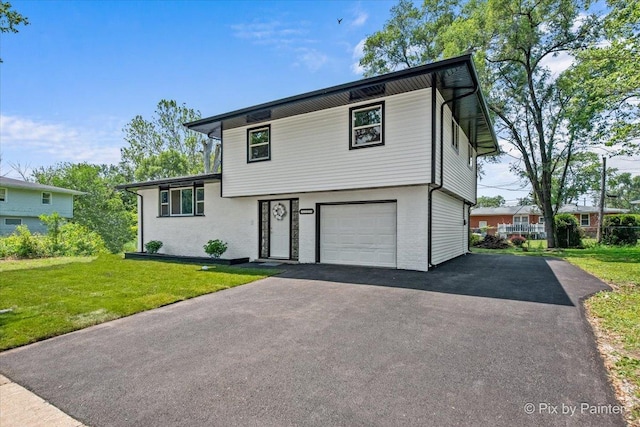 14028 S Wayman Ln, Robbins, IL 60472 - tri-level home featuring a front lawn, an attached garage, and driveway