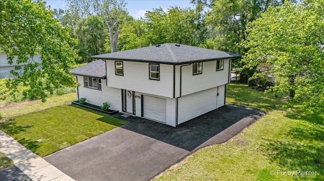 14028 S Wayman Ln, Robbins, IL 60472 - split level home featuring driveway, an attached garage, a front lawn, and a shingled roof